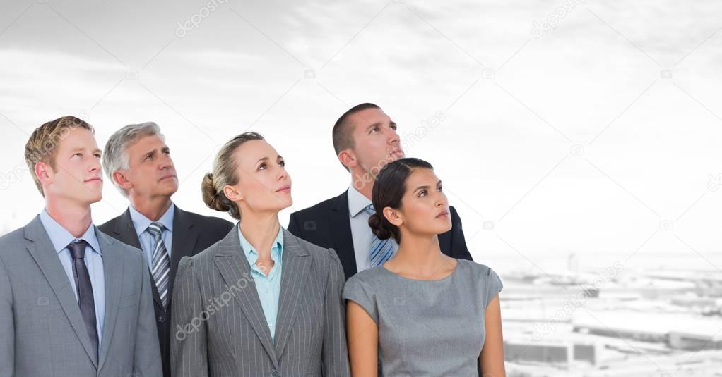 Digital composite of Business people looking up in industrial zone