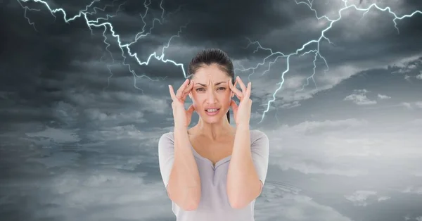 Digital composite of Lightning strikes and stressed woman with headache holding head