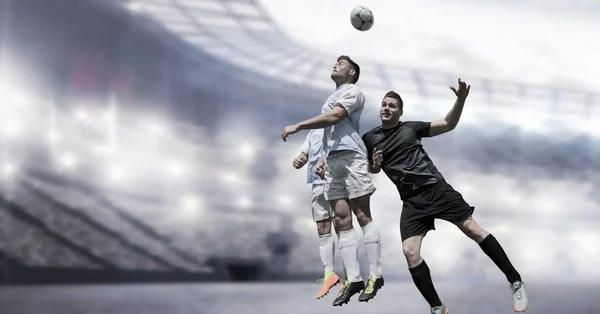 Digital composite of Soccer players heading football in stadium