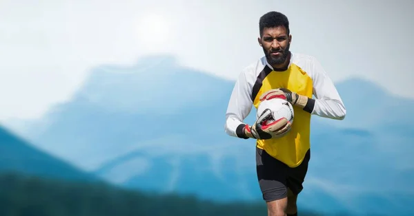 Composto Digital Goleiro Segurando Futebol Com Montanhas Paisagem — Fotografia de Stock
