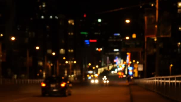 前景には 都市の夜の道路交通のアニメーションとぼやけた都市の光とカラフルなスポット — ストック動画