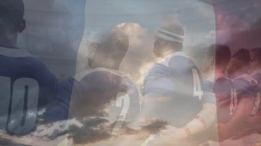 Rugby oyuncularının, maçtan önce ön planda Fransız bayrağı dalgalanan bir stadyumda milli marşı kucaklaması ve söylemesi animasyonu