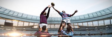 Rugby players against rugby stadium at dawn clipart