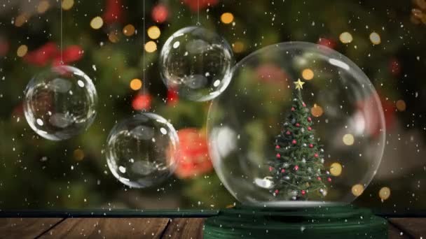クリスマスツリーを背景にしたクリスマス雪の世界のアニメーション ガラスの泡と雪 — ストック動画