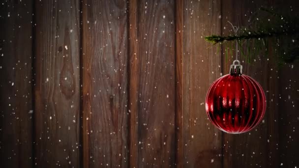 Animation Snow Falling Red Christmas Bauble Wooden Background — Stock Video