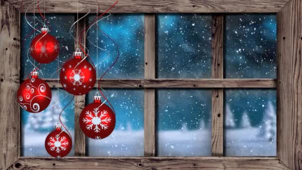 手前に赤いクリスマス ボールが5つある田舎に雪の結晶が降る窓から見る冬の風景のアニメーション — ストック動画
