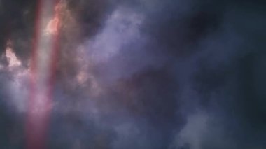 Animation of out of focus multi colored spotlights moving around in hypnotic motion with thunderstorm and moving clouds of smoke in the background. Seamless loop of digital motion.