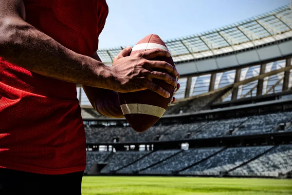 American Football Player against rugby goal post on a sunny day in the stadium