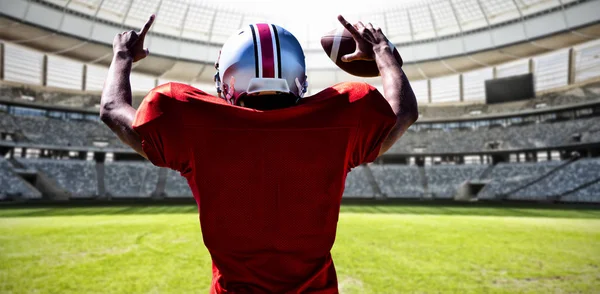 American Football Player against rugby goal post on a sunny day in the stadium