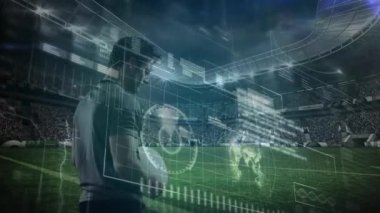 Arka plandaki bir spor stadyumunda rugby maçından önce erkek ragbi oyuncusunun konsantre olduğu veri işleme ve istatistik kaydının animasyonu. 