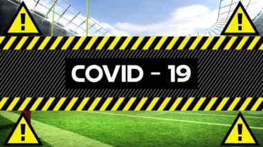 Covid-19 kelimesinin animasyonu sarı ve siyah bantlara siyah harflerle yazılmıştı. Arka planda dört siyah sarı uyarı üçgeni vardı.. 