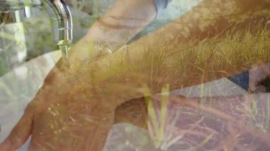 Güneşli bir arka planda güneşli bir günde ağaçlar ve doğa ile Coronavirus covid 19 salgını sırasında musluğun altında ellerini yıkayan bir adamın animasyonu.. 