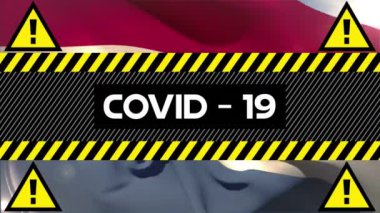 Arka planda Hollanda bayrağı üzerine sarı ve siyah bant üzerine yazılmış Covid-19 sözcüğünün animasyonu. Küresel salgın koronavirüs Covid 19 salgını sosyal uzaklık ve karantina tecrit konseptinde dijital olarak üretilen görüntü.