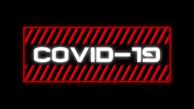 Siyah arkaplanda kırmızı çerçeveyle beyaz harflerle yazılmış Covid-19 kelimesinin animasyonu. Küresel salgın koronavirüs Covid 19 salgını sosyal uzaklık ve karantina tecrit konseptinde dijital olarak üretilen görüntü.