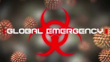 Kırmızı sağlık tehlikesi işareti üzerine yazılmış Küresel Acil Durum kelimelerinin animasyonu, arka planda yayılan makro koronavirüs Covid-19 hücreleri.