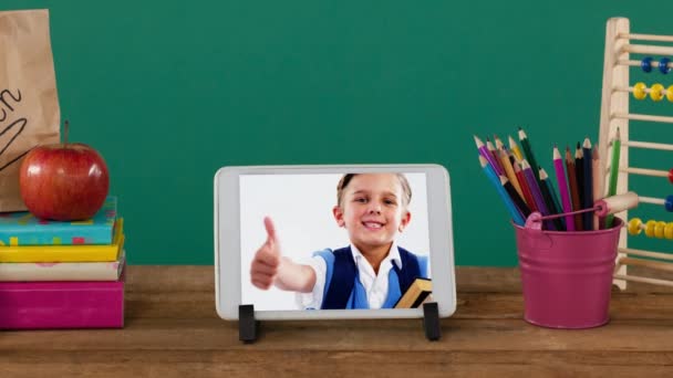 Animation Digital Tablet Showing Caucasian Boy Holding Books Giving Thumbs — Stock Video