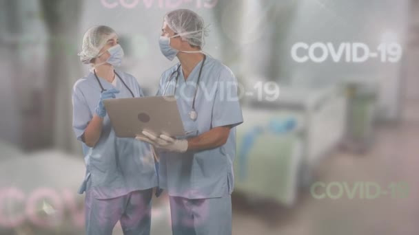 Animatie Van Woorden Covid Zweeft Twee Dokters Die Gezichtsmaskers Dragen — Stockvideo