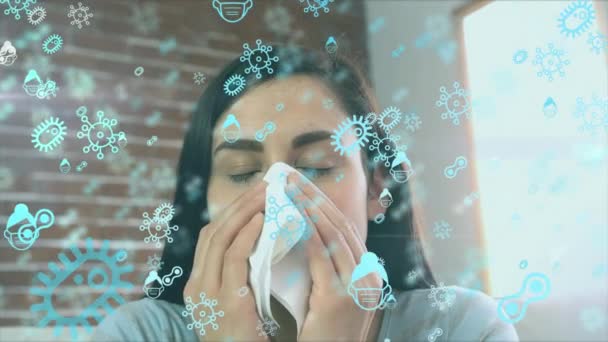 Animation de macros icônes de cellules Covid-19 flottant au-dessus d'une femme caucasienne éternuant dans un tissu au ralenti. Coronavirus Covid-19 pandémie concept composite numérique 