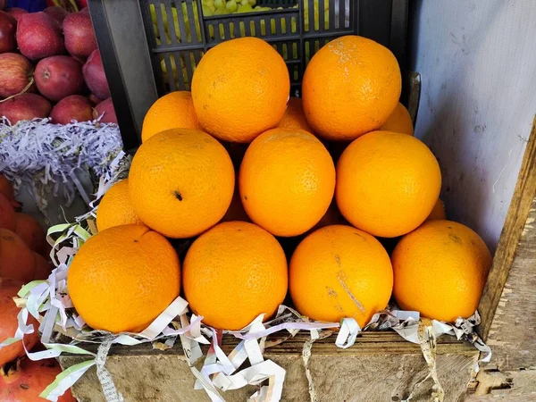 Selling Juicy fresh ripe orange, closeup. Wholesale market. Orange in a box. Selling crops on the market. Natural, healthy, vitamin-rich foods. Food for health. High Vitamin-C fruits.