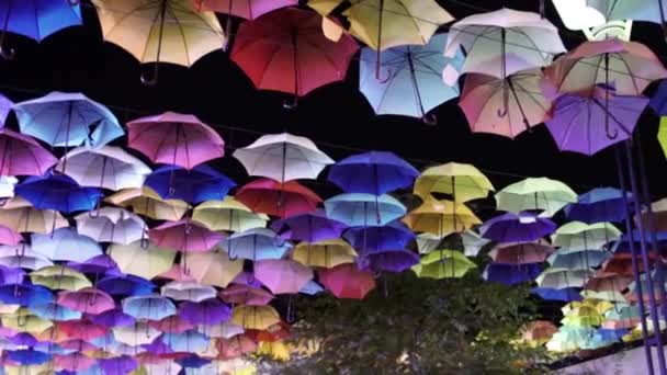 Gata dekorerad med färgade paraplyer på natten — Stockvideo
