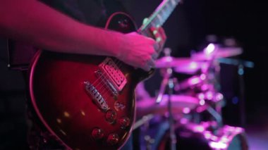 Gitarist sahnede elektro gitar çalıyor.