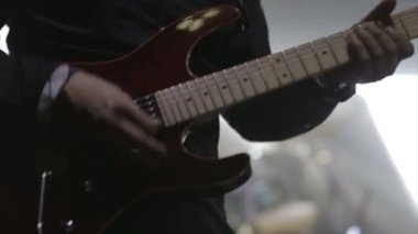 Gitarist sahnede elektro gitar çalıyor.