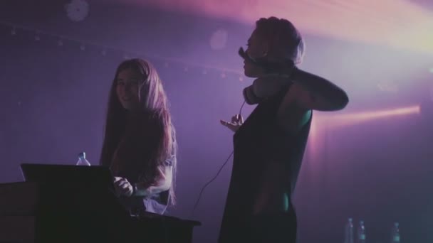 Two women dj play the music on the mixing console in the nightclub — Stock Video