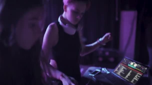 Two women dj play the music on the mixing console in the nightclub — Stock Video
