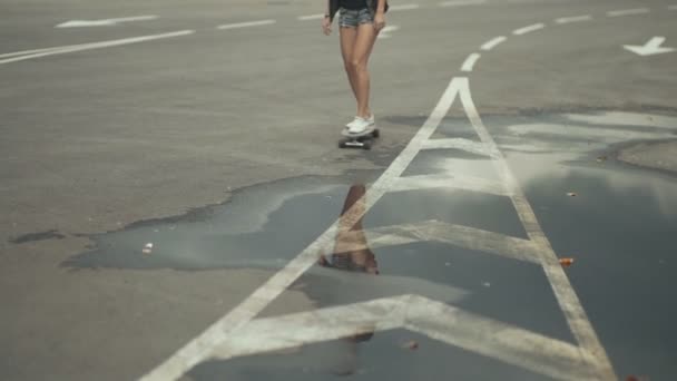 스케이트 보드를 타고 거리를 달리고 있는 젊은 암컷 사냥꾼 — 비디오