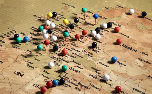 The map is marked with pins of various colors. Europe