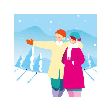 Kış kıyafetleri içinde kar yağışı olan bir çift insan.