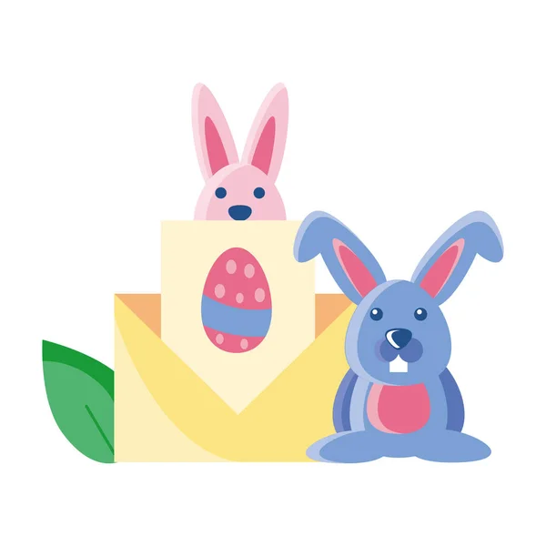 Easter rabbits with an envelope on white background — Stockvector