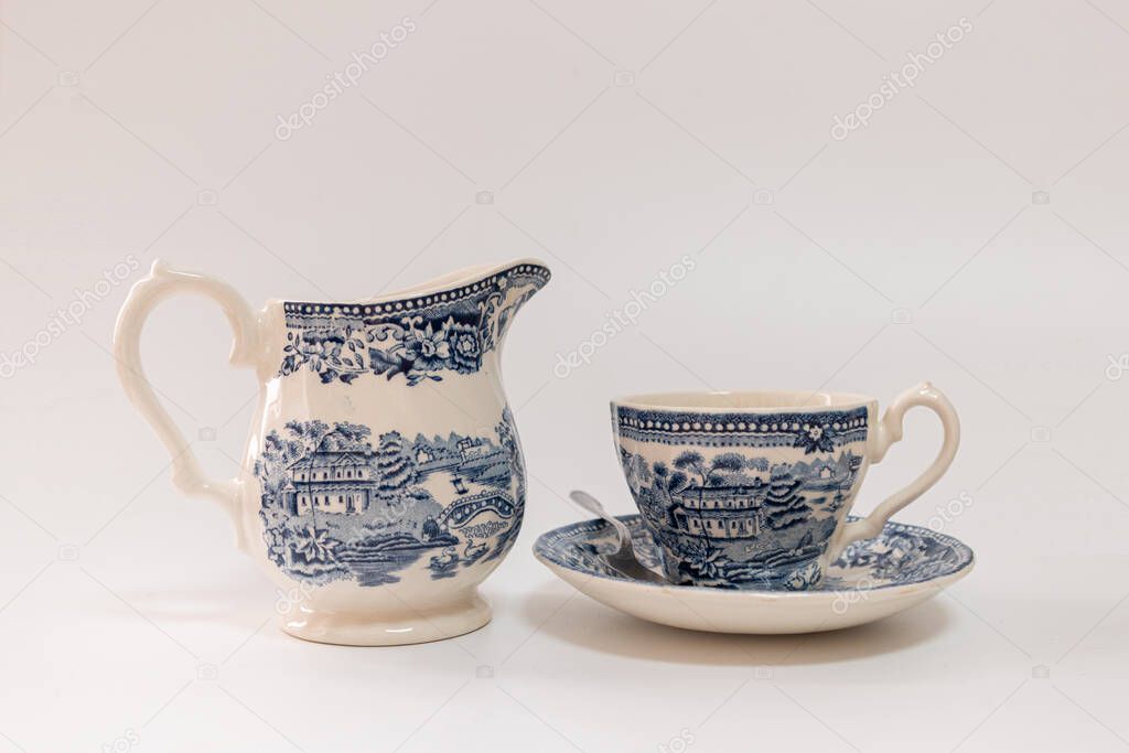 Vintage and old coffee set in blue and white, ornate and baroque style, white background