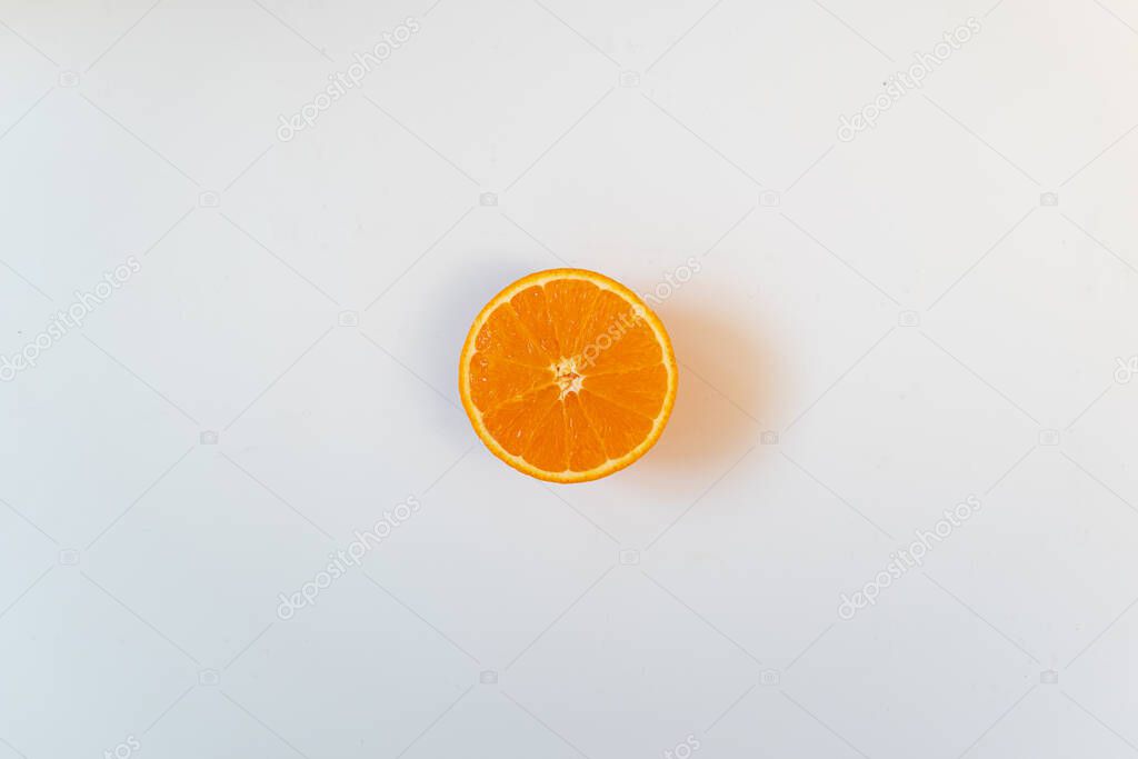 Isolated half orange in a white background. Flat lay, copy space, advertisement