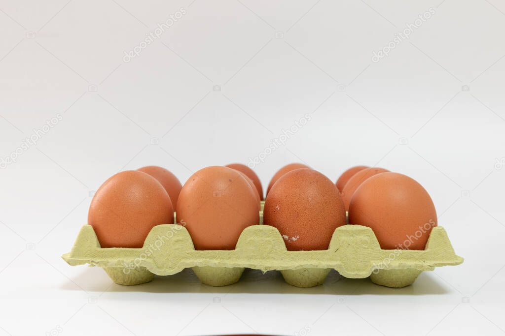 Egg carton full of eggs, to make pastries at home, white background