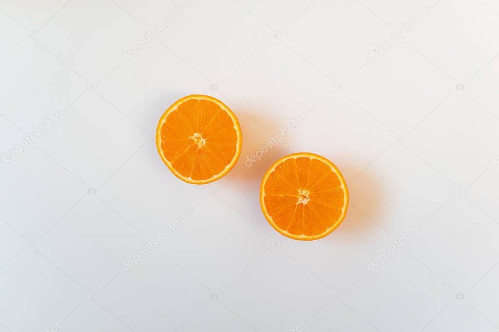 Two half oranges in white background. Healthy fresh fruit, flat lay, copy space