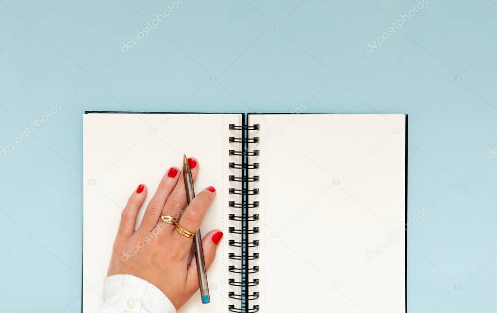 Girl hand in a notebook, ready to learning and accomplish objectives and education goals
