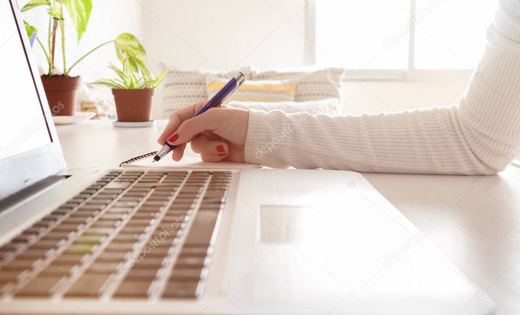 Accounting businesswoman working using laptop at home, telecommuting, working remotely during quarantine