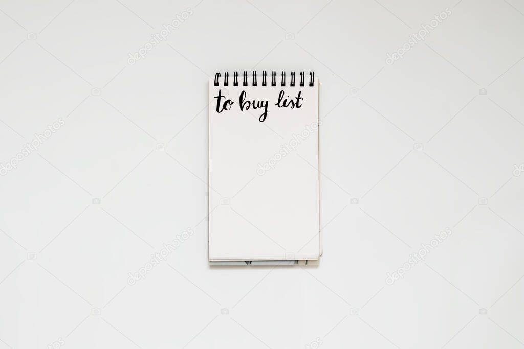To buy list written in notebook, customer deciding and planning what to shop
