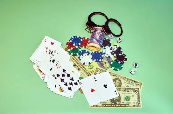 Playing Cards Dollars Dice Chips Handcuffs Light Green Background — Stock Photo, Image