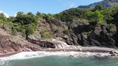 Sea waves, mountains, rocky beach