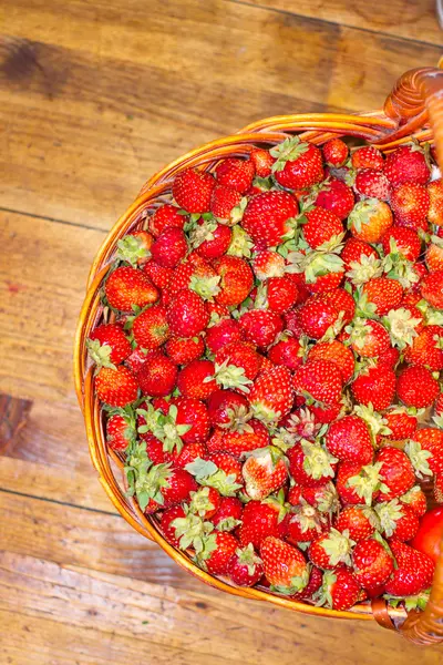 Lot of strawberries on the table in basket. View from above. — Stock Photo, Image