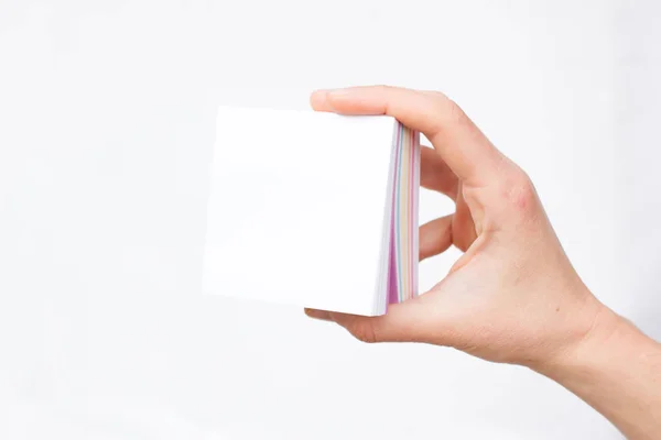 Hand holds notebook open. Blank white paper. Place for an inscription — Stock Photo, Image