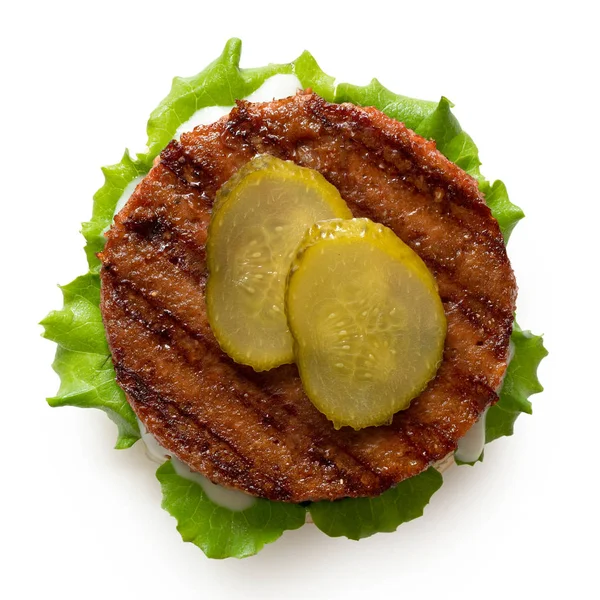 Freshly grilled plant based burger patty on bun with lettuce, sl — Stock Photo, Image