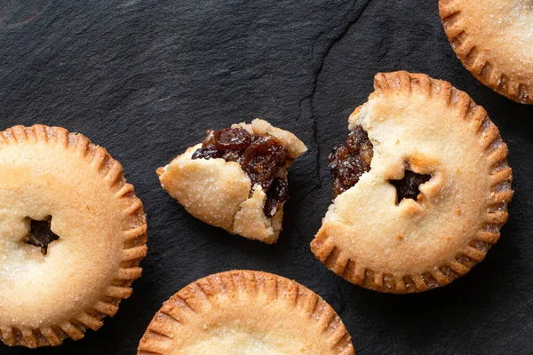 Broken open traditional british christmas mince pie with fruit f