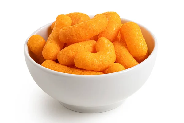 Extruded cheese puffs in a white ceramic bowl isolated on white. — Stock Photo, Image