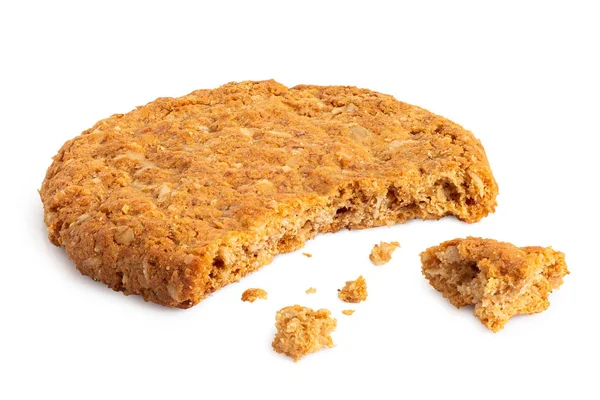 Partially eaten crunchy oat and wholemeal biscuit with crumbs is — Stock Photo, Image