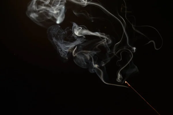 Smoldering aromatic stick in the dark,a lot of blue smoke — Stock Photo, Image