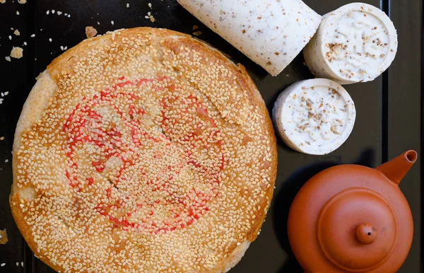 Chinese pancake made from rice-flour , The roll type filled with beans ,the round type filled with taro and sesame  ( ka-nom goh )