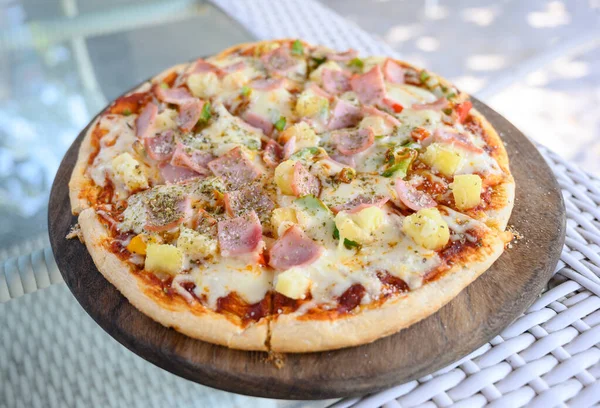 Hawaiian Pizza. Pizza topped up with pineapple, ham, onions, cheese, tomatoes, bacon,Bell pepper and sauce.